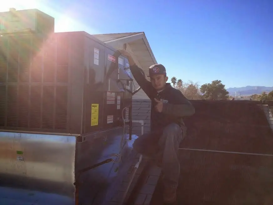 HVAC technician performing AC Tune-Up on a rooftop unit in Obetz